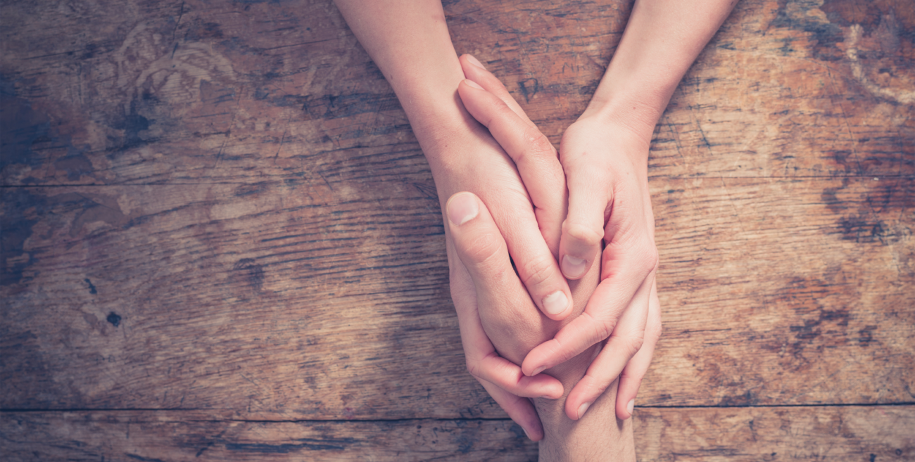 Man and woman holding hands at a table  Full e