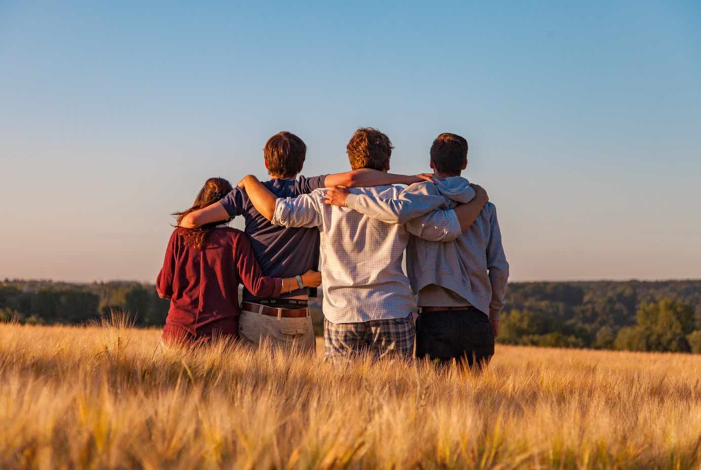 family therapy holding each other in field